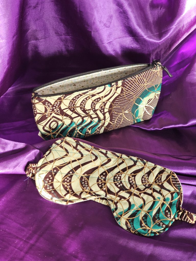 Cream, brown and green gold foiled African wax fabric gift set against purple satin background
