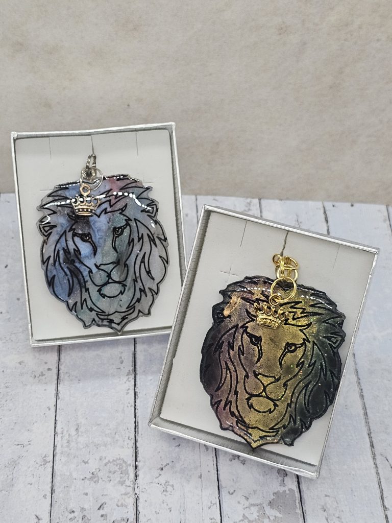 Handpoured resin lion keyrings with small metal charms in silver gift boxes